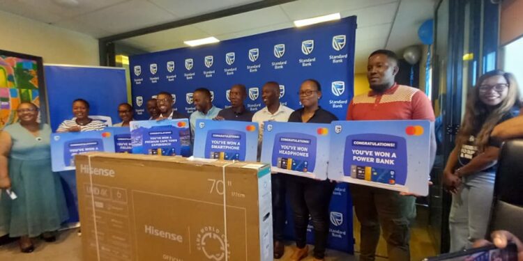 Some of the winners proudly display their prizes after receiving them during the Standard Bank Eswatini Choose Standard Bank campaign prize presentation ceremony in Mbabane.