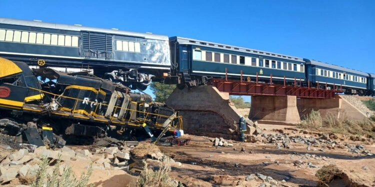 A damaged coach lies off the tracks near Naute in southern Namibia after the Rovos Rail Tours train accident on Sunday morning, where two crew members lost their lives while passengers escaped unharmed.