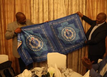 National Commissioner of Police Mr. Manoma Vusie Masango of Eswatini presents a printed copy of the Royal Eswatini Police Lihiya to Mozambique Inspector General His Excellency Joaquim Adriano Sive during a courtesy exchange at Bolana Serena Hotel.