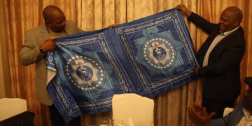 National Commissioner of Police Mr. Manoma Vusie Masango of Eswatini presents a printed copy of the Royal Eswatini Police Lihiya to Mozambique Inspector General His Excellency Joaquim Adriano Sive during a courtesy exchange at Bolana Serena Hotel.