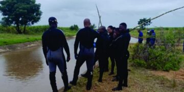 Police scuba divers from the Royal Eswatini Police Service retrieve the body of an eight year old boy from a water canal in Othandweni during a search operation conducted with officers from Siphofaneni on Friday morning.