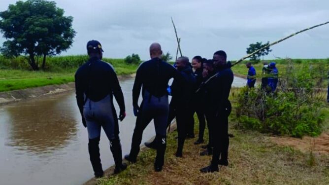 Police scuba divers from the Royal Eswatini Police Service retrieve the body of an eight year old boy from a water canal in Othandweni during a search operation conducted with officers from Siphofaneni on Friday morning.