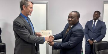 Minister of Finance Neal Rijkenberg shakes hands with a Tanzanian representative after the signing of the Memoranda of Understanding on cooperation in public sector accounting and financial reporting. Photo by Ministry of Finance, Eswatini.