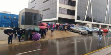 Citizens exposed to rain queuing for govt services