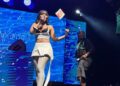 Zee Nxumalo waves Eswatini flag at Farmers Market
